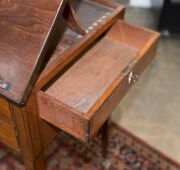 A Sheraton reading table, mahogany with ebony string inlay and bone escutcheon Finely crafted with tilting lid and original brass handles and castors, fitted accessory drawer to the right hand side, late 18th century. A rare and exceptional example. 74cm - 12