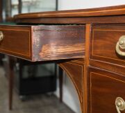 A George III Hepplewhite mahogany sideboard with string inlay and cross banding, finely crafted serpentine front with square form tapering legs, double fronted cellarette drawer to the left hand side, original brass drop handles with attractive reed decor - 12