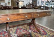 A George III English mahogany library table with embossed green leather top, attractive rounded corners with two drawers and four simulated drawer fronts to the ends and sides, supported on two double concave reeded trestles forming attractive splay legs - 14