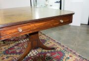 A George III English mahogany library table with embossed green leather top, attractive rounded corners with two drawers and four simulated drawer fronts to the ends and sides, supported on two double concave reeded trestles forming attractive splay legs - 15