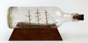 A folk art ship in bottle ornament, 27.5cm wide