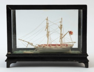 An antique carved bone model ship in case, in the Prisoner of War style, 19th century, 16cm high, 20cm wide, 9cm deep
