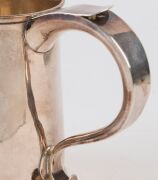 George III English sterling silver ale mug with a raised plinth base and hollow tapering loop handle terminating in a heart-shaped palm rest. By William Grundy of London, circa 1772, 12cm high, 282 grams. - 10