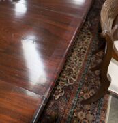 GILLOWS Georgian mahogany extension dining table with fold-over top and concertina undercarriage, eight turned and tapered gun barrel legs with original brass castors, accompanied by mahogany extension leaf holder and four extension leaves, circa 1810, 75 - 12