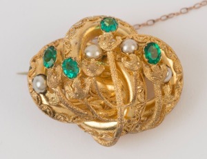 An antique Colonial yellow gold brooch set with green stones and pearls, most likely Sydney origin, 19th century, housed in a plush box branded "PRICE Co. Ltd. Sydney", 4cm wide, 16.5 grams total