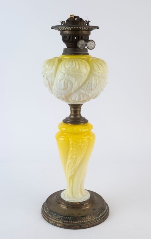 An antique kerosene lamp with duplex white double button burner, embossed lemon glass font and column with brass base, 19th century, ​​​​​​​51cm high overall