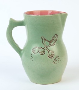SADIE KENNEDY green and pink glazed pottery jug with sgraffito gumnut decoration, incised "S. Kennedy", 15.5cm high