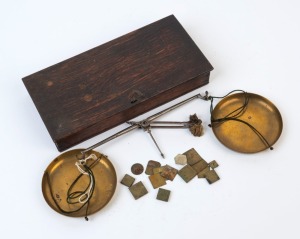 Antique gold scales in dark stained oak case with brass pans and assorted weights, 19th century, the box 20cm wide. PROVENANCE: Private Collection Bendigo