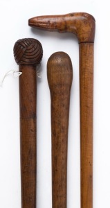 Three Australian antique walking sticks including fiddleback blackwood and eucalypt, one with carved dogs head and one with Turkman knot, 19th century, the largest 94cm high