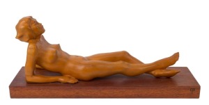 ARTIST UNKNOWN reclining nude sculpture, huon pine and hardwood, circa 1930s, ​​​​​​​22cm high, 54cm long overall