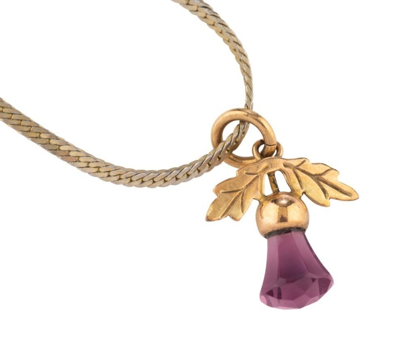 A 9ct yellow gold thistle pendant set with an amethyst, on a later silver chain, 20th century, the chain 56cm long