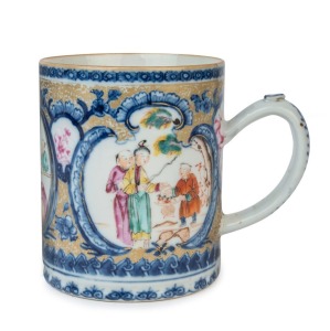 A Chinese export blue and white porcelain tankard with enamel vignettes of domestic scenes and gilt finished highlights, 18th century, 12cm high, 14cm wide