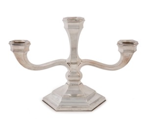 A German Art Deco three branch candelabra by H.M. Wilkens & Sohns, circa 1930, stamped "H.M. Wilkens & Sohns, 835", ​​​​​​​19cm high, 28cm wide, weighted base.