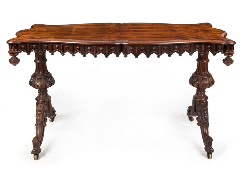 An antique English rosewood centre table with finely carved undercarriage and apron, circa 1865, 76cm high, 136cm wide, 75cm deep