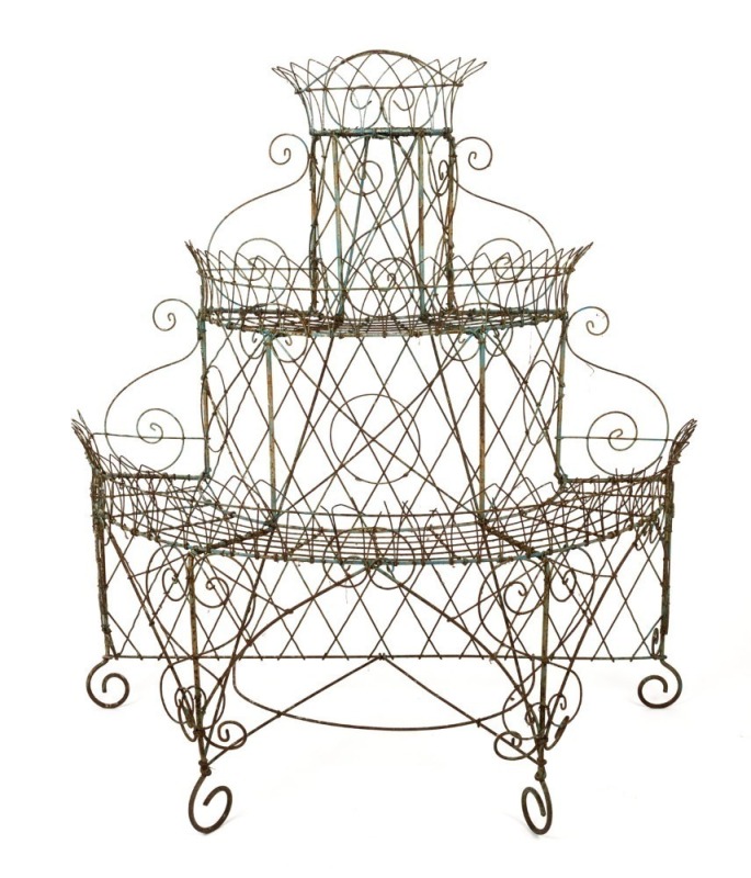 An antique English wirework plant stand, demi-lune form with three cascading shelves, late 19th century, ​​​​​​​120cm high, 112cm wide, 55cm deep