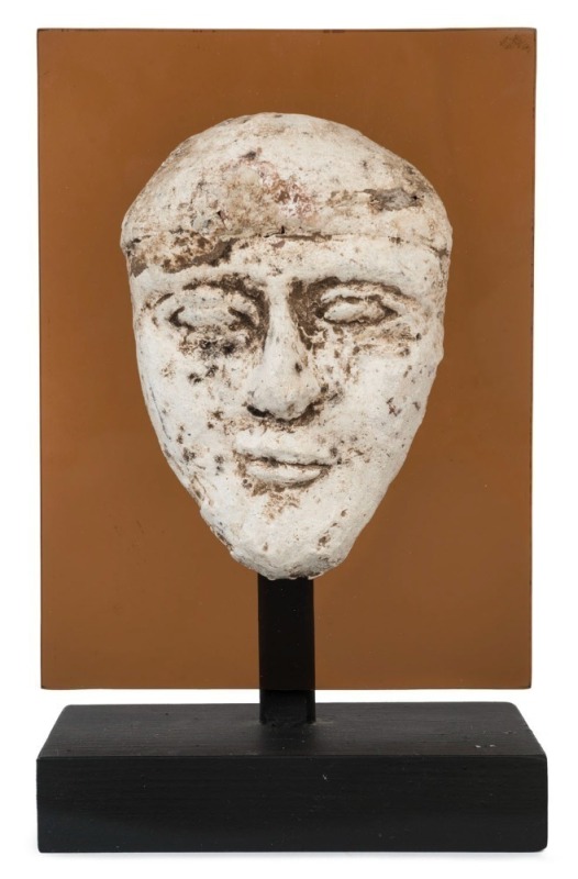 Egyptian male face mask, terracotta overlaid with plaster rendered in typical Hyksos style with large almond shaped eyes, heavy cosmetic lines, broad nose, arching brows and a full set lips. Traces of brown pigment still remaining. Hyksos Period, 15th to