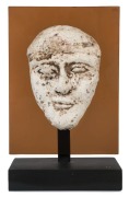 Egyptian male face mask, terracotta overlaid with plaster rendered in typical Hyksos style with large almond shaped eyes, heavy cosmetic lines, broad nose, arching brows and a full set lips. Traces of brown pigment still remaining. Hyksos Period, 15th to