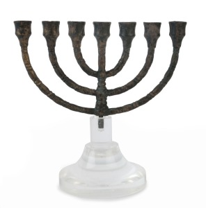 A bronze Menorah lamp stand of classic form with six curved branches and the seventh lamp atop the central pillar. The original base lost in antiquity, the shank that would have joined the body to the base cast in square form. Central Turkey, circa 15th to 16th century A.D. 13cm high, 20cm high overall