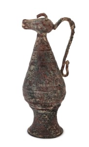 An antique Indo-Persian embossed metal jug with cow pouring spout, 30cm high