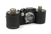 LEITZ: Leica 250 Reporter (GG) 35mm Rangefinder camera [#150164 series], 1943, with Summar f2 50mm lens [#335133], with both film magazines and shutter speed to 1000.