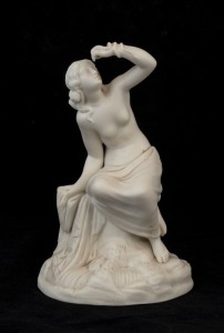 An antique bisque porcelain statue of a seated nude and serpent, 19th century, 23cm high
