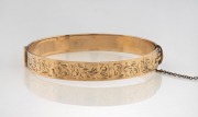 An antique 9ct rolled gold bangle with engraved decoration, 19th century, 6.3cm wide