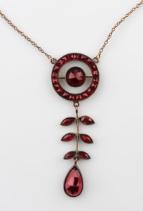 An Edwardian garnet pendant set in gilt silver on a fine rose gold chain (later metal clasp), early 20th century, ​​​​​​​the pendant 4.5cm high, the chain 51cm long