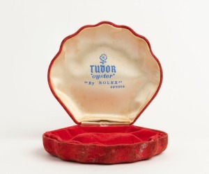 TUDOR OYSTER "BY ROLEX" original vintage red velvet clam-shaped watch box, mid 20th century, 11.5cm wide