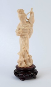 A Chinese carved ivory statue of a lady with fish, early to mid 20th century, 18.5cm high overall