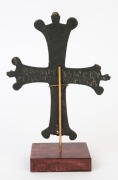 A fine Byzantine bronze crucifix. The front surface engraved with circular motif, the reverse with a dedicatory script written in old Aramaic. 10th to 12th century. 18cm high, 22cm overall - 2