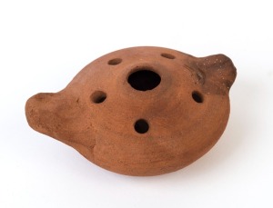 A pottery oil lamp, the upper surface adorned with a Menorah just behind the spout, Palestine / Holyland, circa 4th to 6th A.D. 4cm high