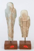 A pair of  Egyptian glazed faience Ushabti figures of classic forms wearing wigs and beards, each holding the crook and flail, the front surface with horizontal bands of hieroglyphs. Late Period, circa 600 to 300 B.C.,   17cm high 14cm high - 2