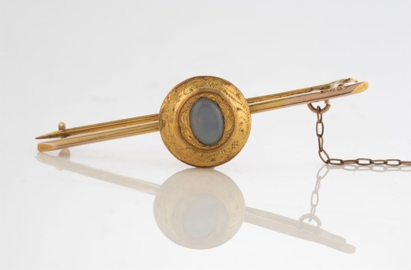 An antique yellow bar brooch set with moonstone, late 19th century, ​​​​​​​4.5cm wide, 3.5 grams total