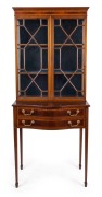 A Sheraton Revival bow front bookcase, mahogany with strong inlay and astragal glazed doors, late 19th century, 188cm high, 79cm wide, 47cm deep