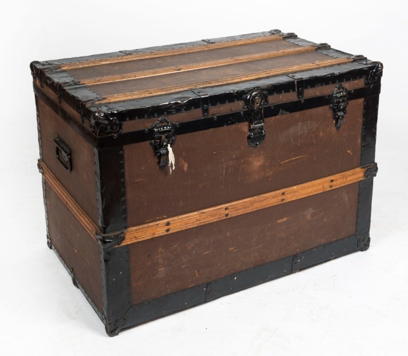 An antique timber and metal bound travel trunk, 19th/20th century, ​​​​​​​with Melbourne details stencilled verso, 61cm high, 85cm wide, 52cm deep