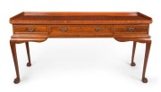 An antique mahogany three drawer servery with tapered legs and claw feet, 19th century, 84cm high, 170cm wide, 60cm deep