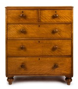 An antique English five drawer chest, satinwood, with brass escutcheons and turned feet, 19th century, with maker's plaque "S. W. Silver & Co, London & Liverpool", 113cm high, 193cm wide, 46cm deep