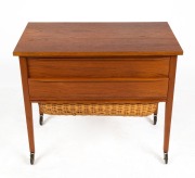 A vintage Danish teak two drawer sewing table with basket undercarriage, circa 1970, 57cm high, 68cm wide, 38cm deep