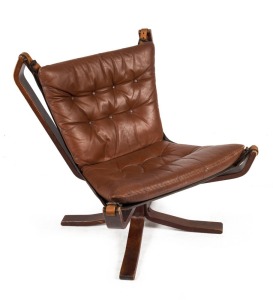 A Scandinavian lounge chair with chocolate leather upholstery, 84cm high