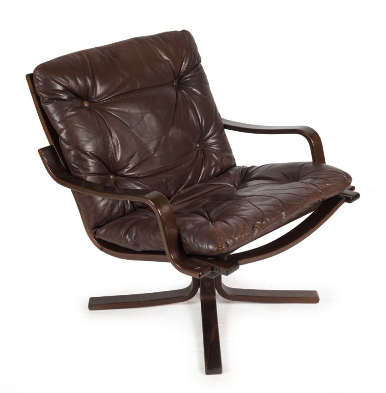 A Scandinavian armchair with chocolate leather upholstery, 79cm high, 74cm across the arms