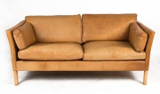 A Scandinavian tan leather two seat settee with square ash legs, 170cm across the arms