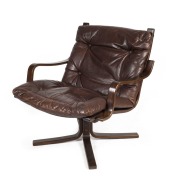 A Scandinavian armchair upholstered in chocolate leather with dark stained frame, 79cm high, 75cm across the arms