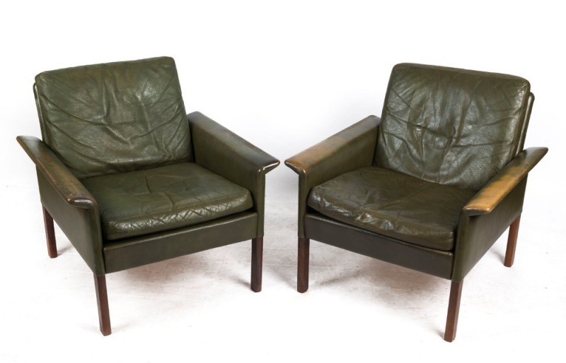 A pair of retro green leather flared armchairs, circa 1960, 76cm across the arms