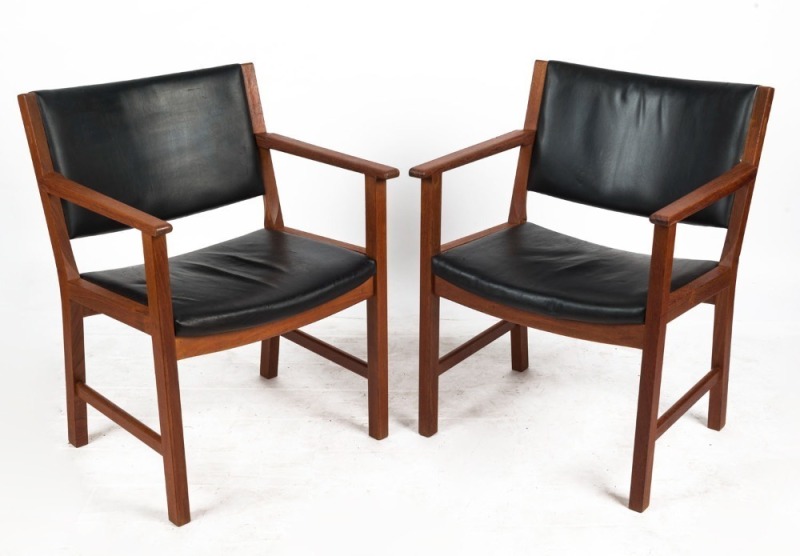 A pair of Danish teak elbow chairs with black vinyl upholstery, 58cm across the arms