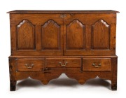 A Georgian oak side cabinet with two doors above three drawers, 18th century, 104cm high, 140cm wide, 50cm deep