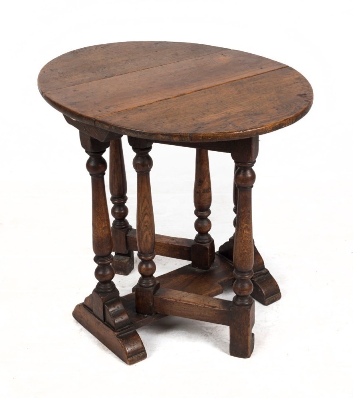 An antique English oak gate-leg oval drop-side occasional table of petite proportions, 19th century, 52cm high, 21cm (extends to 59cm) wide, 47cm deep