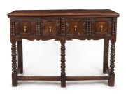 A Charles II antique English oak two drawer servery table, finely crafted with bobbin legs and turnings, peg joint construction and tear drop brass handles, 17th century, 87cm high, 124cm wide, 43cm deep