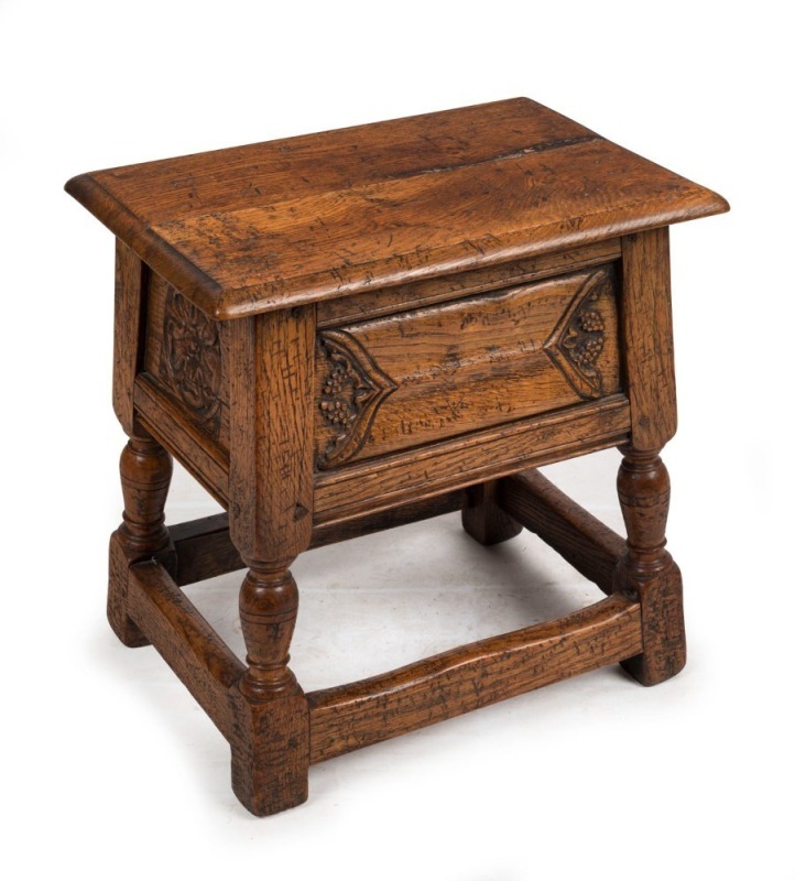 An antique English tapering oak stool with carved panels and lift-top storage, late 18th century, 44cm high, 44cm wide, 30cm deep