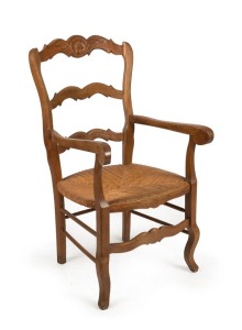 A French provincial oak carver chair with rush seat, 19th century, 100cm high, 54cm across the arms