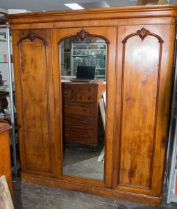 An antique Australian huon pine and cedar three door wardrobe with central mirrored door, 19th century, 211cm high, 195cm wide, 58cm deep